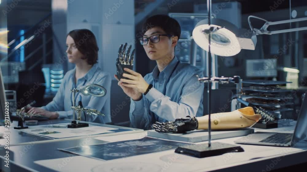Aufkleber futuristic prosthetic robot arm being tested by a professional japanese development engineer in a hi