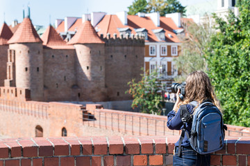 Warsaw, Poland Famous Barbican old town historic city during summer day and red orange brick wall...
