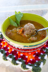 Homemade Romanian sour meatball soup "ciorba de perisoare"