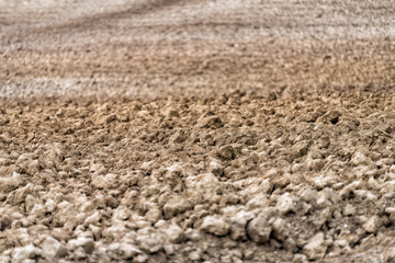 Val D'Orcia countryside in Tuscany, Italy with rolling plowed brown hills farm landscape meadow field furrows in autumn late summer