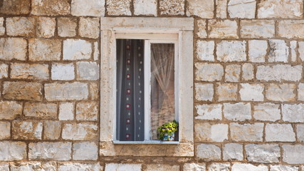 Old window shutters in ancient stone wall