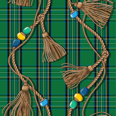 Scottish-style checkered pattern with golden weaves of ropes, tassels and beads. Tartan. Wool green fabric.