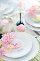 Fototapeta na wymiar Beautiful table setting with crockery and flowers for Easter celebration.