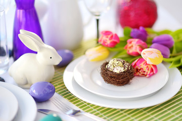 Beautiful table setting with crockery and flowers for Easter celebration.