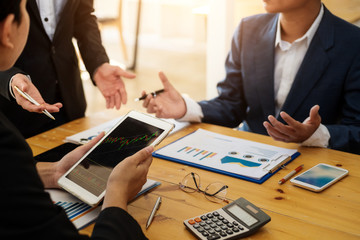 Business people working with discussing and analysis graph stock in tablet at office room.