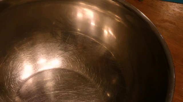 Pouring Red Sauce Into A Silver Pot On Wooden Table