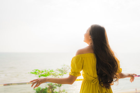 Portrait Beautiful Young Asian Woman Smile Happy And Relax At Outdoor Balcony With Sea Beach And Ocean View