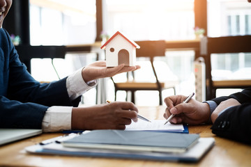 Real estate broker explain contract investment before signing a contract housing estate in office....