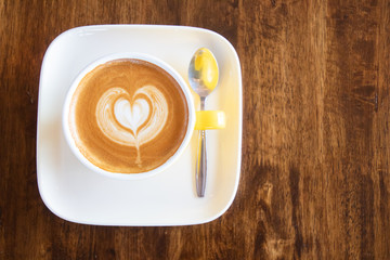 Coffee cup with latte art foam on wood table in coffee shop with copy space.Coffee is one of the most popular beverages.Improve Energy Levels and Burn Fat