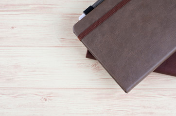 Mockup closed diary with pen on wooden background.selective focus shot,copy space for text.