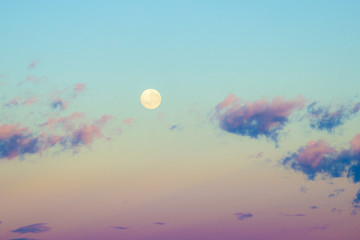Dawn sunrise pink clouds in sky with full moon background. Beautiful skies. Sunset inspiring view...