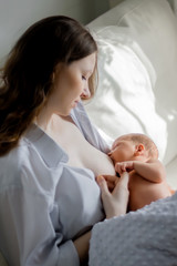 mother feeding her newborn with breast