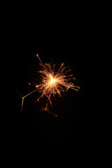 Fototapeta premium yellow sparks on a black background