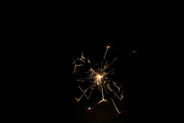 Fototapeta premium yellow sparks on a black background