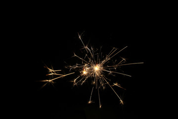 Fototapeta premium yellow sparks on a black background