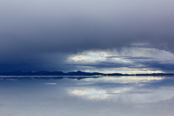 Uyuni salt lake in Bolivia. Dark clouds.