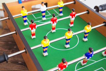 Table football game with yellow and red players and white goalkeeper. Table soccer game.