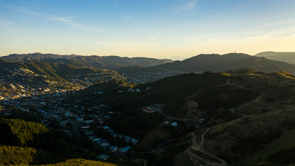 High Aerial View Of Sunset and Shadows Over Wellington Suburban Neighborhoods of Karori 