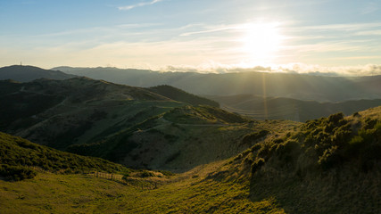 Obraz premium Sunset over hills of Karori out to Makara wind farms, Aerial view 