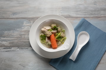 Chicken soup with Matzah balls (Kneidlach) carrots in the bowl. Jewish traditional Passover Pesach holiday food