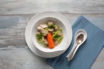 Chicken soup with Matzah balls (Kneidlach) carrots in the bowl. Jewish traditional Passover Pesach holiday food