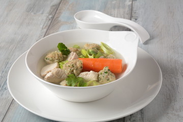 Chicken soup with Matzah balls (Kneidlach) carrots in the bowl. Jewish traditional Passover Pesach holiday food