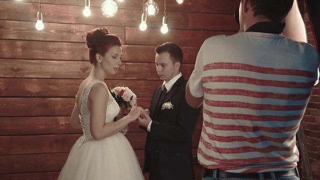 Photographer photographs newlyweds during wedding ceremony