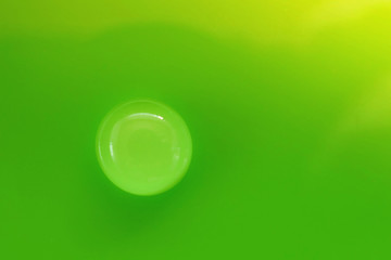 green drop.Round Water drop macro on green background.Conservation concept. Ecology and nature.Water drop phone wallpapers   