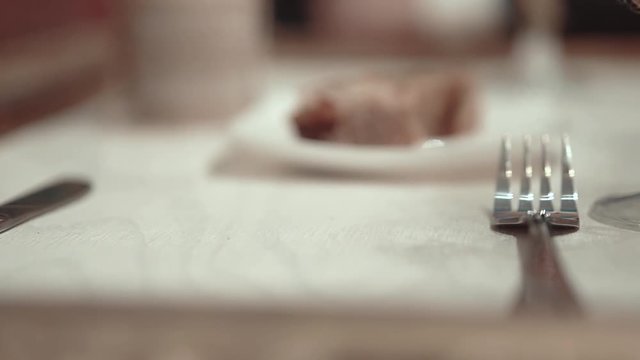 waiter at restaurant sets the table, close-up, slow motion