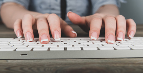 Female office worker typing on the keyboard