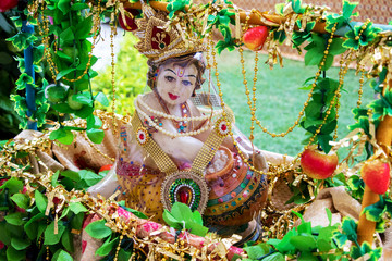 The Hindu God, Lord Krishna, in his childhood form, eating butter