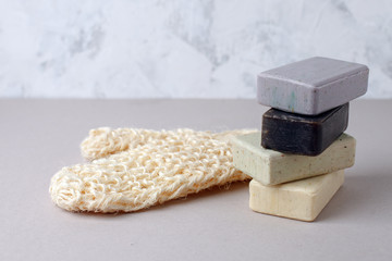 Stacked natural soap, and natural bast sponge for bath. Zero waste background, plastic free bathroom and home. Trendy minimalism, copy space