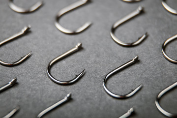 lots of fishing hooks on black background
