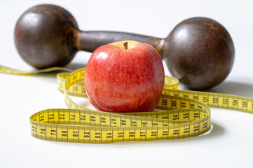 dumbbell Apple and meter the concept of a healthy lifestyle