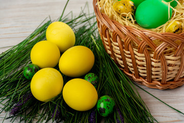 Fototapeta na wymiar Easter eggs in the basket and with fake grass