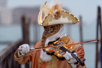 Venetian mask playing illuminated violin © phokrates