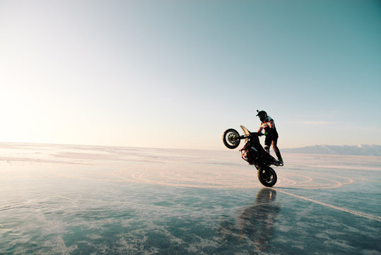 Guy Riding On One Wheel On A Bike