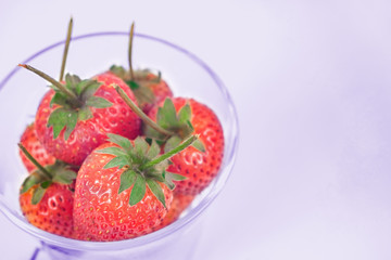 Group of Strawberries in glass on background.