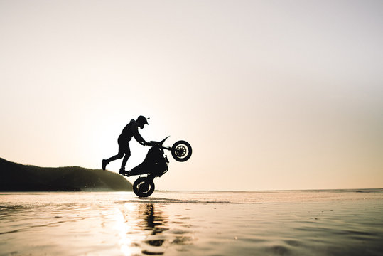 Guy Riding On One Wheel On A Bike