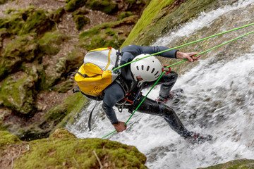 man practicing canyoning - obrazy, fototapety, plakaty