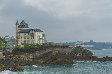 Fototapeta na wymiar House on rocks by coastline in Biarritz, France