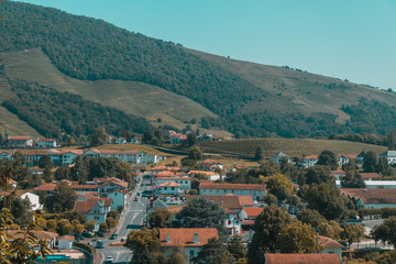 Fototapeta na wymiar Town of Saint-Jean-Pied-de-Port under hills and blue sky in the Basque Country of France