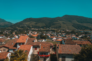 Fototapeta na wymiar Town of Saint-Jean-Pied-de-Port under hills and blue sky in the Basque Country of France