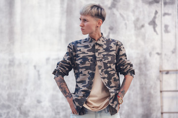 Stylish young European woman brutal with short haircut, rebel, a variety of people