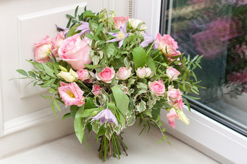 Wedding bouquet is at the window. Bouquet of pink flowers