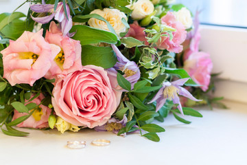 Two wedding rings in flowers. Close up. Engagement