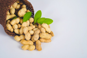 Peanut spill out of basket on background.