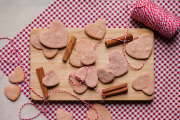 Saint Valentine's morning surprise: home made heart shaped biscuits served on a wooden board with cinnamon. Happy