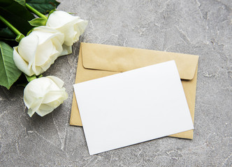 White roses and greeting card