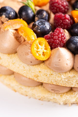Fresh delicious homemade cake with berries on wooden table